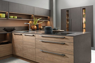 Large industrial u-shaped open plan kitchen in Other with medium wood cabinets, laminate benchtops, ceramic floors, a peninsula, grey floor and grey benchtop.