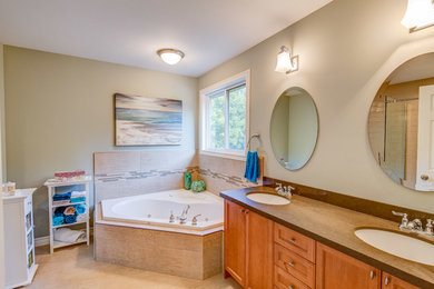 Inspiration for a mid-sized modern master beige tile and porcelain tile porcelain tile bathroom remodel in San Diego with recessed-panel cabinets, medium tone wood cabinets, beige walls, an undermount sink, laminate countertops and a two-piece toilet