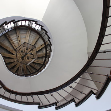 Custom Circular 3-Story Walnut Stair With Iron BalustersS
