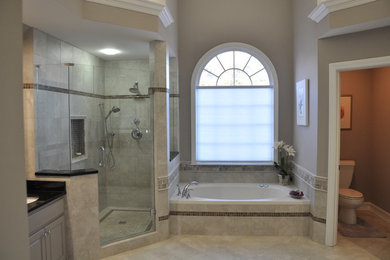 Mid-sized elegant master gray tile and porcelain tile porcelain tile bathroom photo in Atlanta with raised-panel cabinets, gray cabinets, a two-piece toilet, gray walls, an undermount sink and granite countertops
