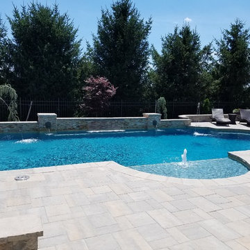 Roman Style Pool with raised wall, fire pit & outdoor kitchen
