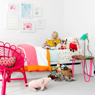 Inspiration for a contemporary children’s room for girls in New York with white walls and carpet.