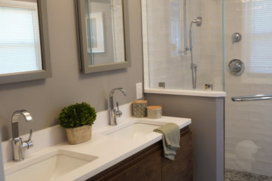 Inspiration for a mid-sized eclectic master black and white tile and subway tile cement tile floor and white floor corner shower remodel in Philadelphia with furniture-like cabinets, dark wood cabinets, a two-piece toilet, gray walls, an undermount sink, quartz countertops, a hinged shower door and white countertops