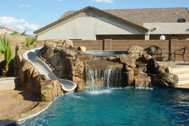 Example of a mid-sized backyard custom-shaped lap water slide design in Phoenix