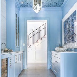 Design ideas for a transitional galley kitchen pantry in Dallas with an undermount sink, recessed-panel cabinets, blue cabinets, white splashback, no island, grey floor and white benchtop.