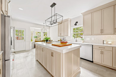 Mid-sized transitional u-shaped eat-in kitchen photo in Birmingham with recessed-panel cabinets, beige cabinets, quartz countertops, an island and white countertops