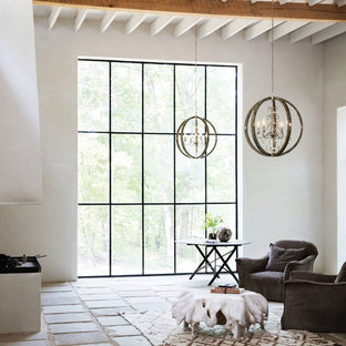 Imagen de salón para visitas abierto, mediterráneo, de tamaño medio, sin chimenea y televisor, con paredes blancas, suelo de baldosas de terracota y suelo multicolor