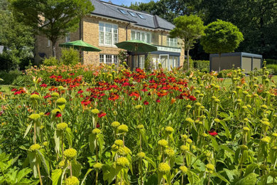 Design ideas for an expansive country back formal full sun garden for summer in Sussex with a flowerbed.