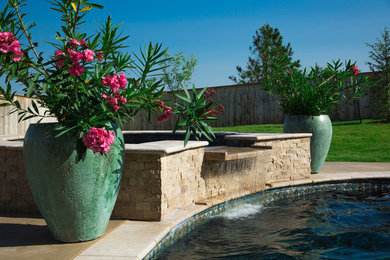 Pool - large tropical backyard custom-shaped and stone natural pool idea in Oklahoma City