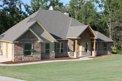 Large traditional brown one-story brick exterior home idea in Dallas with a hip roof