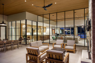 Large minimalist back porch photo in Austin with a roof extension