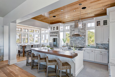 Inspiration for a timeless u-shaped eat-in kitchen remodel in Miami with matchstick tile backsplash, multicolored backsplash, white cabinets, stainless steel appliances, marble countertops and shaker cabinets