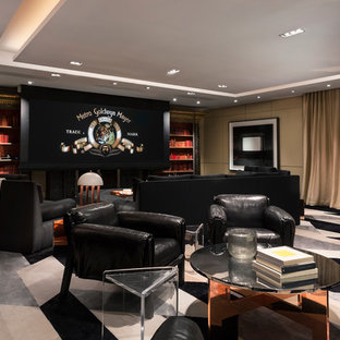 Photo of an expansive traditional open plan home cinema in Los Angeles with beige walls, carpet, a built-in media unit and black floors.