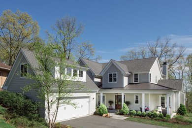 Large country beige two-story concrete fiberboard exterior home idea in DC Metro with a mixed material roof