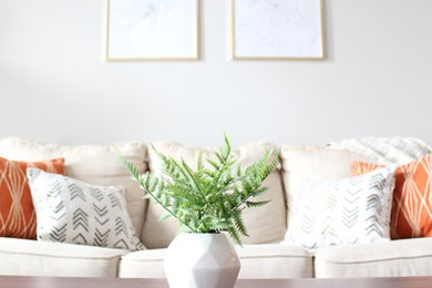 Mid-sized danish open concept medium tone wood floor and gray floor living room photo in Raleigh with a wall-mounted tv