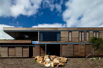 Large contemporary two-storey exterior in Melbourne with wood siding and a flat roof.