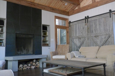 Family room - mid-sized rustic open concept dark wood floor and brown floor family room idea in Other with white walls, a standard fireplace and a metal fireplace