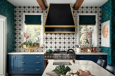 Inspiration for an eclectic dark wood floor and exposed beam kitchen remodel in Denver with an undermount sink, blue cabinets, quartz countertops, stainless steel appliances, an island and white countertops