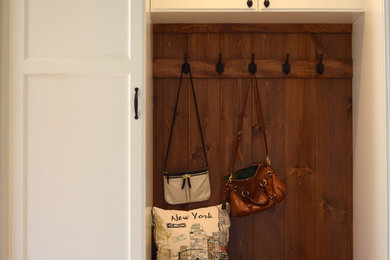 Example of a mid-sized transitional ceramic tile entryway design in New York with beige walls and a white front door