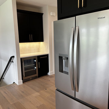 Black and Maple Wheat Kitchen with Brass Banded Hood