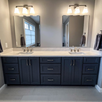 Primary Bathroom with Blue-Gray Vanity and Deep Blue Tiled Feature Wall