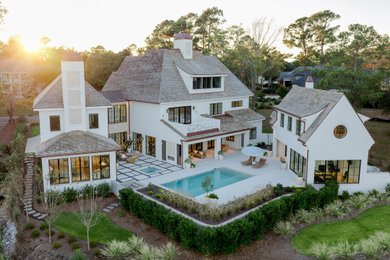 Inspiration for a huge french country white stucco house exterior remodel in Other