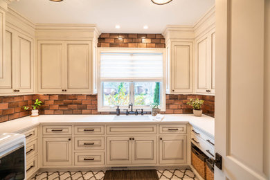 Inspiration for a mid-sized transitional white floor dedicated laundry room remodel in Cleveland with an undermount sink, white cabinets, quartzite countertops, brown backsplash, subway tile backsplash, a side-by-side washer/dryer and white countertops