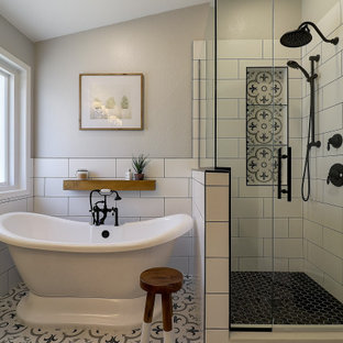 Mid-sized cottage master black and white tile and porcelain tile porcelain tile, multicolored floor, double-sink and vaulted ceiling bathroom photo in Phoenix with shaker cabinets, gray cabinets, a two-piece toilet, gray walls, an undermount sink, quartz countertops, a hinged shower door, white countertops, a niche and a built-in vanity