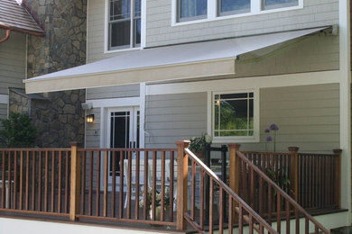 Inspiration for a large backyard deck remodel in Chicago with an awning