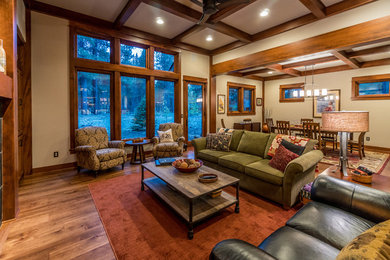 Photo of a mid-sized formal open concept living room in Other with medium hardwood floors, a standard fireplace, a tile fireplace surround and a concealed tv.