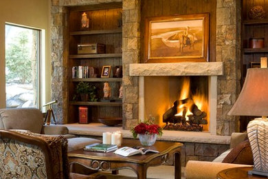 Inspiration for a mid-sized country formal enclosed living room in Denver with beige walls, carpet, a standard fireplace, a stone fireplace surround, no tv and beige floor.