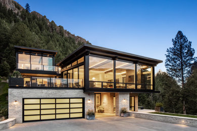 Large trendy white three-story mixed siding house exterior photo in Denver with a shed roof