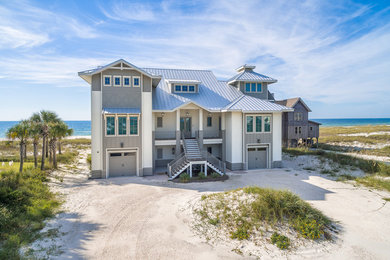 Large coastal gray three-story mixed siding exterior home idea in Birmingham with a hip roof