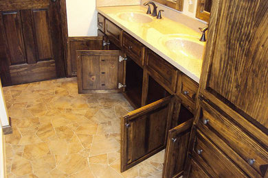 Bathroom - large rustic master beige tile vinyl floor bathroom idea in Other with raised-panel cabinets, dark wood cabinets, a two-piece toilet, white walls, an integrated sink and quartz countertops