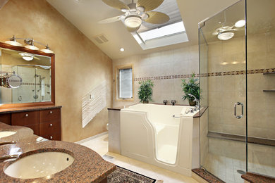 Photo of a mid-sized transitional master bathroom in San Diego with flat-panel cabinets, medium wood cabinets, an alcove tub, a corner shower, brown walls, ceramic floors, an undermount sink, granite benchtops, beige tile, ceramic tile, beige floor and a hinged shower door.