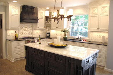 Elegant l-shaped eat-in kitchen photo in New York with beaded inset cabinets, white cabinets, granite countertops, orange backsplash and paneled appliances