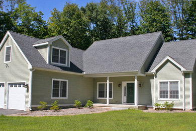 Mid-sized elegant green two-story wood exterior home photo in Bridgeport