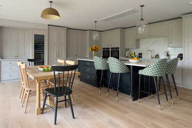 Inspiration for a large traditional open plan kitchen in Other with shaker cabinets, engineered stone countertops and an island.