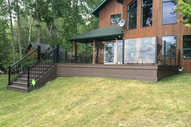 Mid-sized mountain style brown two-story wood gable roof photo in Calgary