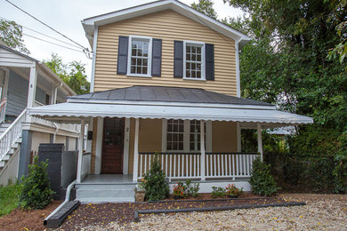 Example of a beige two-story exterior home design in Charleston