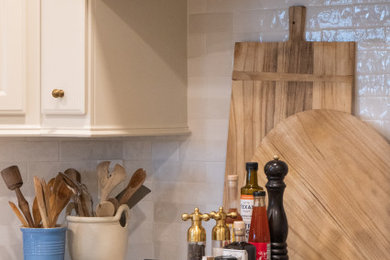 Large transitional l-shaped dark wood floor and brown floor eat-in kitchen photo in Houston with an undermount sink, raised-panel cabinets, white cabinets, quartz countertops, gray backsplash, ceramic backsplash, stainless steel appliances, an island and white countertops