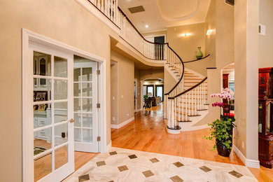 Inspiration for a large contemporary light wood floor double front door remodel in Los Angeles with gray walls and a dark wood front door