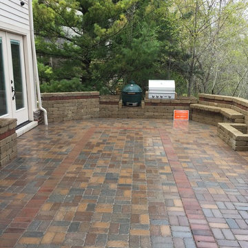 Outdoor Kitchen with  fireplace, dining area and seating wall