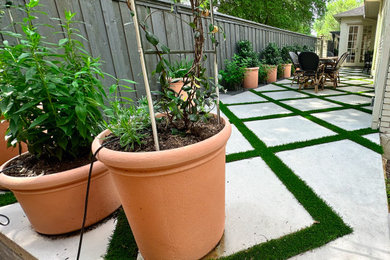 Photo of a modern shade backyard concrete paver and wood fence landscaping in Dallas for spring.