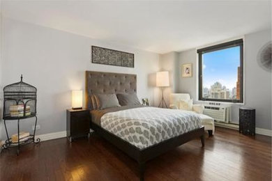Inspiration for a mid-sized transitional master dark wood floor and brown floor bedroom remodel in New York with gray walls