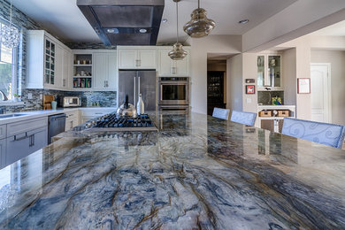 Inspiration for a large contemporary l-shaped cement tile floor and beige floor eat-in kitchen remodel in San Diego with an undermount sink, shaker cabinets, beige cabinets, granite countertops, multicolored backsplash, glass tile backsplash, stainless steel appliances and an island
