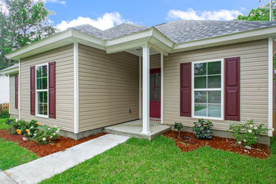 Mid-sized arts and crafts beige one-story vinyl gable roof photo in New Orleans