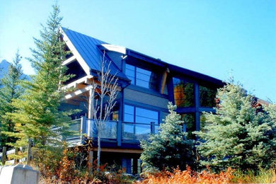 Huge mountain style backyard deck photo in Calgary