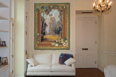 Example of a large classic formal and enclosed light wood floor and brown floor living room design in San Francisco with yellow walls, a standard fireplace, a stone fireplace and no tv