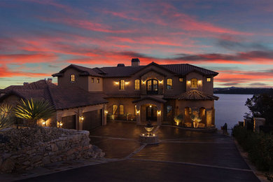 Huge mountain style beige three-story stucco exterior home photo in Dallas